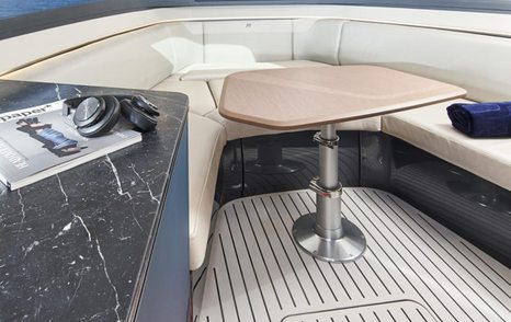 Princess R35 interior dinette area, with U shaped sofa in the bow, fixed table and surface on port side