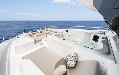 Forward deck of  Horizon FD87 with large sunpads and jacuzzi