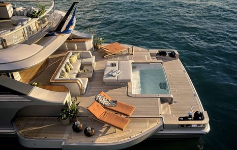 Overview of Benetti Oasis 40m Beach Club, infinity pool centre, surrounded by sun loungers.