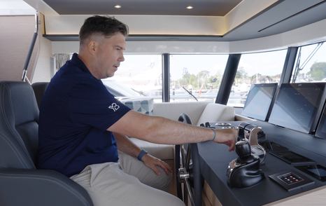 Beneteau Grand Trawler 63 lower helm featuring engine controls, joystick and comfortable skipper's seat