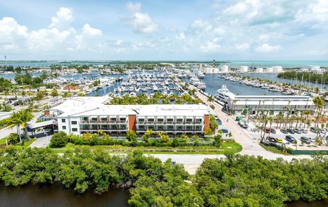 Overview of Stock Island Marina Village – FL Keys, surrounded by sea and green foliage