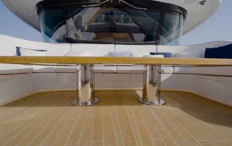 U-shaped foredeck seating aboard the Gulf Craft Majesty 145 with teak dining table