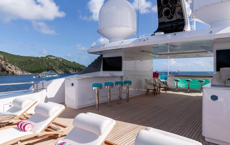 Superyacht Asia's sundeck with stools and sunpads