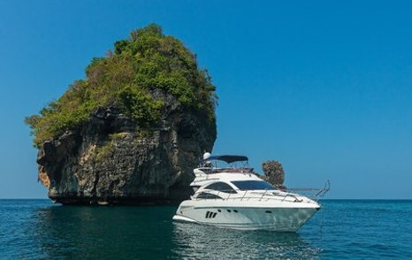 small motor cruiser on anchor at remote island