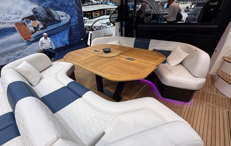 Next-Gen Beneteau Gran Turismo 50 motor yacht aft deck C-shaped seating around wooden table