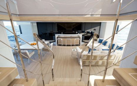 Rendering of the Baglietto T60 superyacht stairway down to beach club interior with L-shaped sofa and bar area 