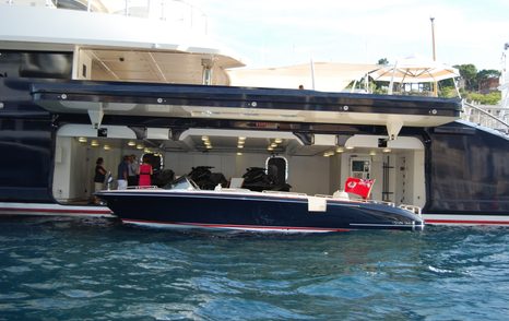 Open tender garage onboard Superyacht MAN OF STEEL, tender visible being moved out of garage for use.