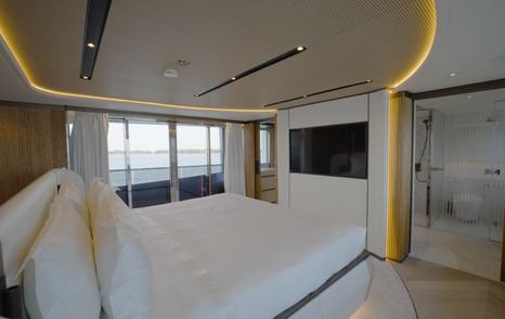 Owner's suite aboard the Gulf Craft Majesty 145 with ensuite access and fold-down balcony doors