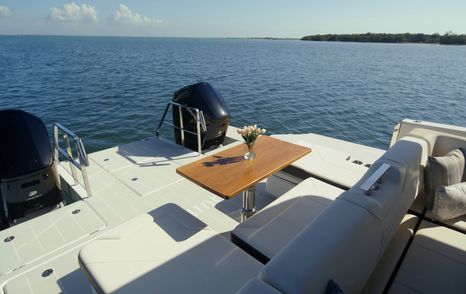 Aquila 45 Sport cockpit seating with convertible dining table, showing open layout and connection to swim platform
