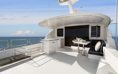 Horizon E90 motor yacht aft upper deck with integrated L-shaped seating