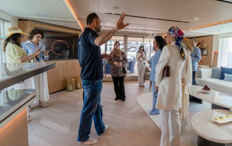 People being shown around saloon of Gulf Craft Majesty 145 Superyacht Suzie Q