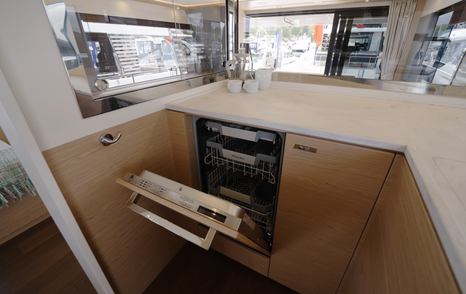 Beneteau Grand Trawler 63 galley featuring integrated dishwasher and Corian worktops
