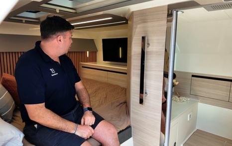 Aquila 45 Sport cabin entrance view showing bed, storage and access to head, demonstrating practical overnight layout