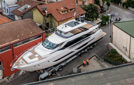 Elevated view of Ferretti Yachts 860 on tarmac. Surrounded by buildings.