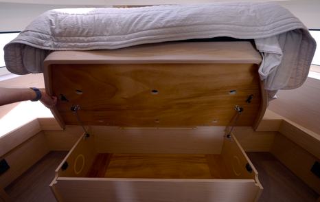 Storage compartment beneath the island berth in the Beneteau Swift Trawler 37 Fly owner's cabin