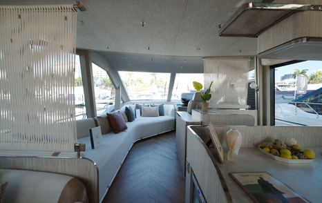 Main deck interior aboard the Galeon 620 Fly showing the relationship between galley and saloon spaces.