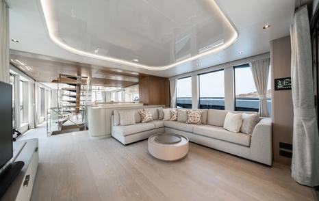 Sunseeker 85 Ocean Enclosed motor yacht main saloon with grey L-shaped sofa