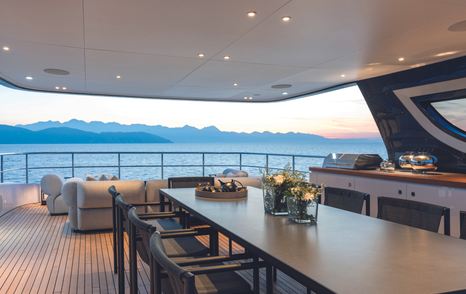 Alfresco dining set up with exterior lounge onboard Oasis 34M.