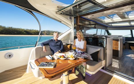 Riviera-6000-Sport-Yacht-Platinum-Edition-Review-aft-cockpit-dining-and-lounge-area-daytime