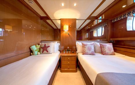 Guest twin cabin on superyacht Rebecca V, with wood detailing