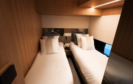 De Antonio D60 twin guest cabin with hull windows and wood finishes