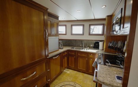 Nordhavn 75 EYF U-shaped galley with domestic appliances, extensive storage and granite countertops