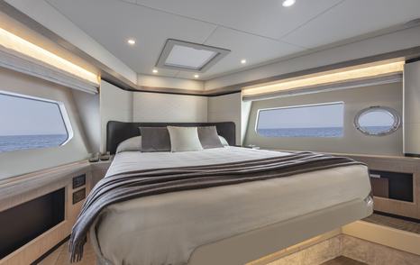 VIP cabin onboard Absolute 50Fly, central berth surrounded by windows