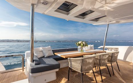 The alfresco dining section on board a Pearl 95 motor yacht.