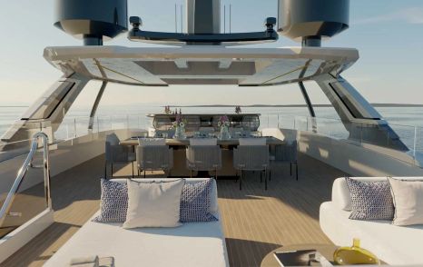 The flybridge features a dining area and relaxed seating