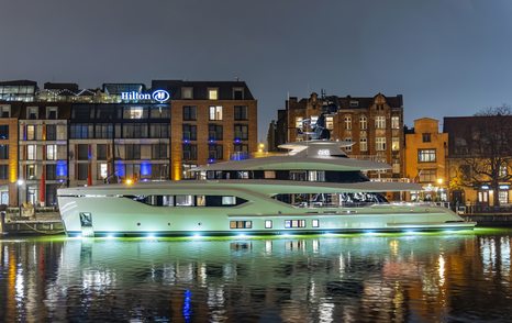 ACE C144S yacht shown at night with city scape in background, port side profile shown