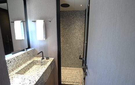 Benetti Oasis 34M twin guest cabin ensuite bathroom with stone vanity, walk-in shower and modern fittings.