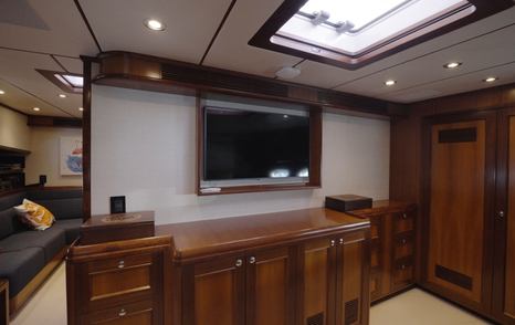 Nordhavn 75 EYF owner's cabin with custom cabinetry, television and overhead skylight