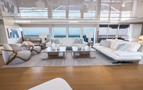 Superyacht Evelyn P's main saloon seating area with white furniture and chairs