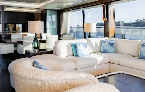 Motor Yacht Triple Eight main saloon curved sofa seating area with contemporary interior finishes