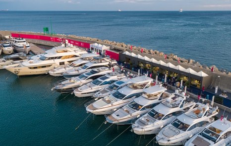 Motor yachts lined up along the marina during Genoa Yacht Show