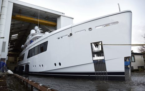 Feadship CALLISTO emerging from hangar at Feadship facility.