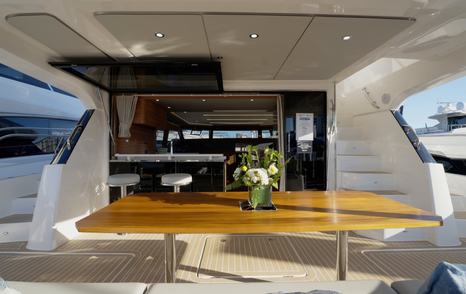 Aquila-46-Yacht-Review-cockpit-dining-table-and-drop-down-tv