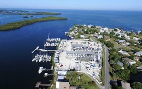 Aerial view of Shell Point Marina – Tampa Bay, multiple boats and yachts moored, surrounded by sea and green foliage