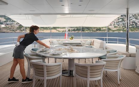 Superyacht Philosophy's aft deck with circular dining table 