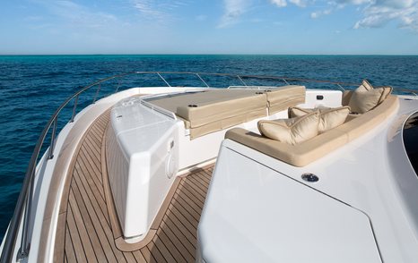 Bow area onboard Viking 75 MY, sunpads and padded seating facing forward, surrounded by sea.