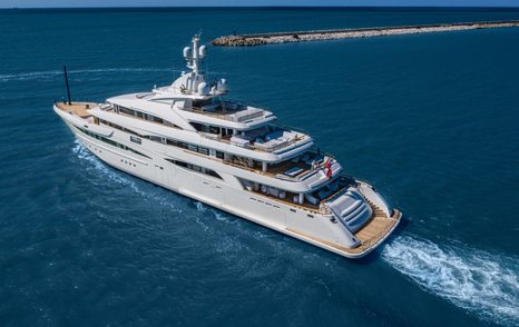 CRN superyacht MIMTEE shown in aerial view, running shot, port quarter deck and along port side profile, blue sea, bright day