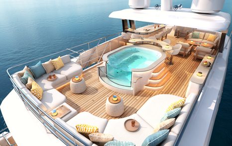 Overview of the aft deck onboard motor yacht MOONSHINE with a glass-fronted Jacuzzi and white seating