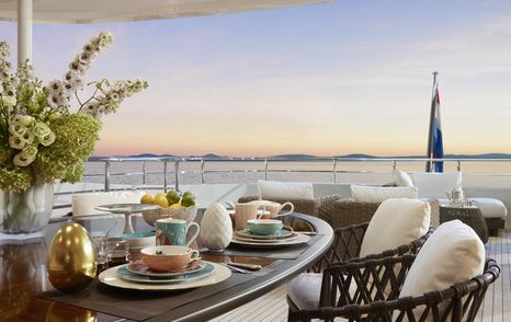 Sky deck onboard Heesen 'Project Triton', al fresco dining table and chairs, overlooking sea