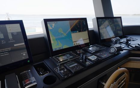 Navigation displays and engine controls on the Gulf Craft Majesty 100 Terrace bridge