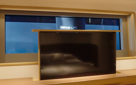Custom Line Navetta 38 VIP cabin pop-up TV rising in front of window within built-in storage unit