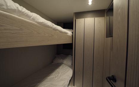 Pearl 73 crew cabin with two bunk berths and storage