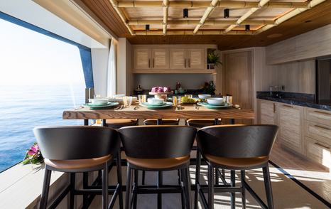 Expedition Yacht King Benji wooden bar next to window 