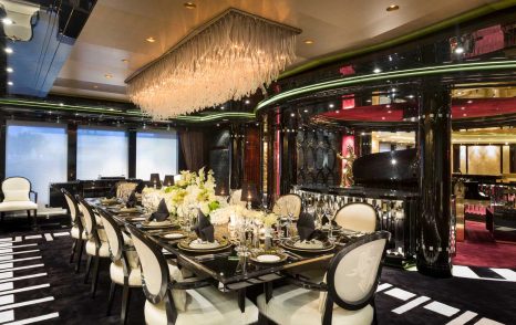 Lurssen yacht PHOENIX 2 opulent dining area under ceiling light feature, the dining table is set for at least ten guests