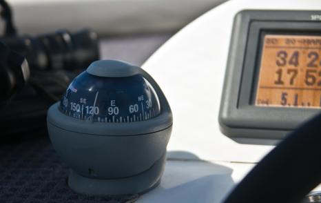 compass with chart plotter in background