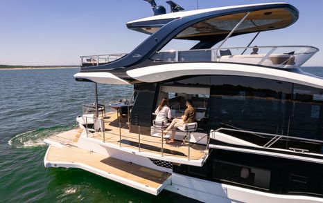 Aft cockpit and fold-down terrace aboard the Galeon 620 Fly at anchor.